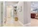 Inviting hallway featuring tile flooring, wall decor, and access to other rooms at 12906 Tar Flower Dr, Tampa, FL 33626