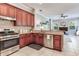 Updated kitchen with stainless steel appliances and a seamless flow to the living area with a fireplace at 12906 Tar Flower Dr, Tampa, FL 33626