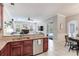 Open kitchen with stainless steel appliances, granite countertops, and a view of the backyard pool at 12906 Tar Flower Dr, Tampa, FL 33626