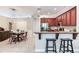 Kitchen featuring a breakfast bar, stainless steel appliances, and wood cabinetry at 12906 Tar Flower Dr, Tampa, FL 33626
