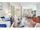 Bright and open living space features hardwood floors, neutral colors, and large windows at 12906 Tar Flower Dr, Tampa, FL 33626