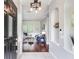 Bright living room with hardwood floors, an elegant light fixture, and cozy seating area at 12906 Tar Flower Dr, Tampa, FL 33626