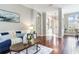 Open-concept living room features rich wood floors, fresh paint and plenty of natural light at 12906 Tar Flower Dr, Tampa, FL 33626