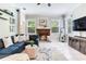 Inviting living area with a fireplace, plush seating, and a view of the outdoors at 12906 Tar Flower Dr, Tampa, FL 33626