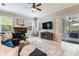 Cozy living room with fireplace, comfortable seating, and access to an outdoor area at 12906 Tar Flower Dr, Tampa, FL 33626