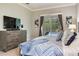Comfortable main bedroom with soft carpet, a flat screen tv and pool views at 12906 Tar Flower Dr, Tampa, FL 33626