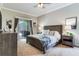 Bright main bedroom with a rustic wood bed frame and sliding doors to the screened patio at 12906 Tar Flower Dr, Tampa, FL 33626