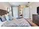 Cozy main bedroom with plush carpet, flat screen tv, and views of backyard at 12906 Tar Flower Dr, Tampa, FL 33626