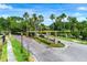 Beautiful neighborhood entrance with mature landscaping, brick pillars, and a decorative community sign at 12906 Tar Flower Dr, Tampa, FL 33626
