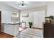 Well-lit office featuring an accent rug, ceiling fan and office desk space at 12906 Tar Flower Dr, Tampa, FL 33626