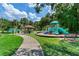 View of the community playground with a covered picnic area and lush trees, perfect for families at 12906 Tar Flower Dr, Tampa, FL 33626