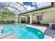 Inviting screened-in pool area with an adjacent patio, outdoor seating, and a grill for comfortable outdoor living at 12906 Tar Flower Dr, Tampa, FL 33626