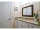 Bathroom featuring a granite countertop vanity, modern lighting, and neutral wall color at 15124 Springview St, Tampa, FL 33624