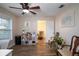 Cozy home office featuring wood floors, a ceiling fan, and a view to the dining room at 15124 Springview St, Tampa, FL 33624