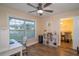 Bright home office features wood floors, a ceiling fan, and natural light at 15124 Springview St, Tampa, FL 33624