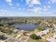 An aerial view of lakeside homes showcases community living near the water at 1730 Sunset Point Rd, Clearwater, FL 33755