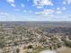 Overhead shot of a community, featuring tree-lined streets and a peaceful lake at 1730 Sunset Point Rd, Clearwater, FL 33755