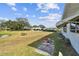 Spacious backyard featuring an expansive lawn and glimpses of the neighborhood setting at 1730 Sunset Point Rd, Clearwater, FL 33755