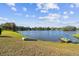 Lakeside property with direct access featuring a dock and gentle shoreline at 1730 Sunset Point Rd, Clearwater, FL 33755
