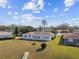 An aerial view of the home shows a lush lawn, mature trees, and a cozy atmosphere at 1730 Sunset Point Rd, Clearwater, FL 33755
