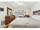 Bedroom features a wooden bed frame and a dresser with a mirror, carpeted flooring, and soft lighting at 1730 Sunset Point Rd, Clearwater, FL 33755