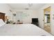 Bedroom features a wooden bed frame, closet, carpeted flooring, and a view to a connected room at 1730 Sunset Point Rd, Clearwater, FL 33755