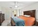 Cozy bedroom with a ceiling fan, closet space, and natural light at 1730 Sunset Point Rd, Clearwater, FL 33755