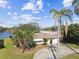 Lovely single-story home with mature landscaping, including palm trees and waterfront access at 1730 Sunset Point Rd, Clearwater, FL 33755