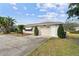 Single story home with an attached two car garage and mature landscaping at 1730 Sunset Point Rd, Clearwater, FL 33755