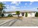 Charming single story home with mature landscaping and a spacious driveway at 1730 Sunset Point Rd, Clearwater, FL 33755