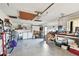 Garage features a laundry area, workspace, and shelving for organized storage at 1730 Sunset Point Rd, Clearwater, FL 33755