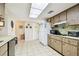Well-lit kitchen with white appliances and light wood cabinets at 1730 Sunset Point Rd, Clearwater, FL 33755