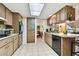 Efficient kitchen with oven, tiled floors and wood cabinets at 1730 Sunset Point Rd, Clearwater, FL 33755