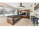 Cozy living room boasts natural light, a ceiling fan, and a large entertainment center at 1730 Sunset Point Rd, Clearwater, FL 33755