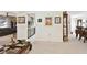 Open living room with dining area, brown sofa, and light neutral carpet at 1730 Sunset Point Rd, Clearwater, FL 33755