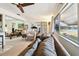 Bright living room with neutral decor, ceiling fan, and beautiful water view at 1730 Sunset Point Rd, Clearwater, FL 33755