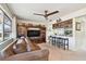 Comfortable living room featuring a ceiling fan, breakfast bar, and entertainment center at 1730 Sunset Point Rd, Clearwater, FL 33755