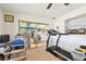 Bonus room featuring a treadmill, office space, and an entrance to living room at 1730 Sunset Point Rd, Clearwater, FL 33755