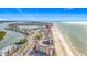 Aerial view of a condo building and surrounding residential area near the beach, with a waterway at 18304 Gulf Blvd # 217, Redington Shores, FL 33708