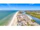 Expansive aerial view of beachfront condos featuring long stretches of sandy beach and river views at 18304 Gulf Blvd # 217, Redington Shores, FL 33708