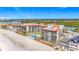 Aerial view of the condo buildings with beach access and community pool amidst surrounding neighborhood at 18304 Gulf Blvd # 217, Redington Shores, FL 33708