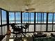 Enjoy Gulf views from this covered balcony featuring seating and ceiling fan at 18304 Gulf Blvd # 217, Redington Shores, FL 33708