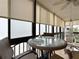 Relaxing balcony with wicker furniture and stunning ocean views through large windows at 18304 Gulf Blvd # 217, Redington Shores, FL 33708