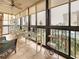 Enclosed balcony with tiled floor, ceiling fan, and seating area with views to beach at 18304 Gulf Blvd # 217, Redington Shores, FL 33708
