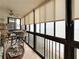 Enclosed balcony features tile flooring and panoramic views of the beach through large windows at 18304 Gulf Blvd # 217, Redington Shores, FL 33708