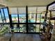 Relaxing balcony with ocean and pool views, decorated with cozy seating and stylish decor at 18304 Gulf Blvd # 217, Redington Shores, FL 33708