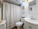 Cozy bathroom with striped shower curtain and white vanity at 18304 Gulf Blvd # 217, Redington Shores, FL 33708