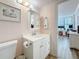 Bathroom with white vanity, and seashell decor; view to bedroom/office space at 18304 Gulf Blvd # 217, Redington Shores, FL 33708