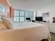 Bedroom with ample natural light, a king sized bed, TV, and desk space at 18304 Gulf Blvd # 217, Redington Shores, FL 33708