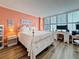 Comfortable bedroom with desk space, a king size bed, and ample light from windows at 18304 Gulf Blvd # 217, Redington Shores, FL 33708